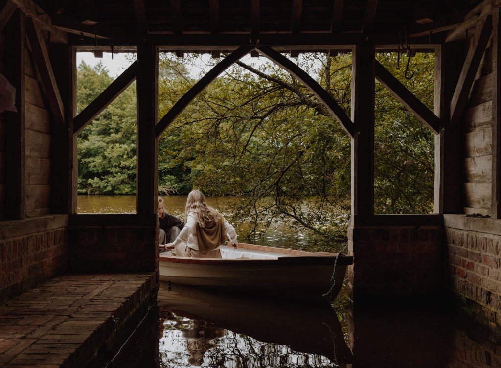 Photo of individual rowing a boat, at the on-site lake