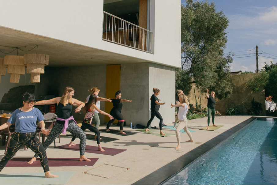 Yoga by the infinity pool at our luxury surf villa on our Surf and Yoga retreat and adventures in Portugal